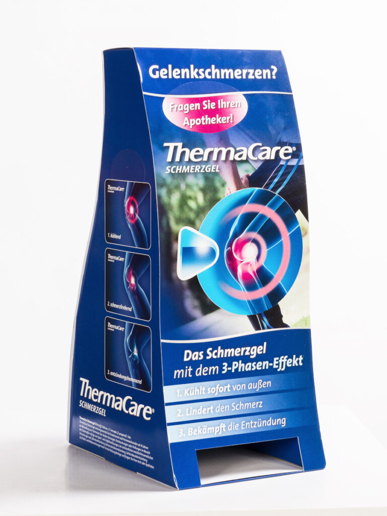 Beispiel für ein Thekendisplay in geschwungener Form, auf allen Seiten bedruckt. Das Display enthält ein Entnahmefach für das Produkt.